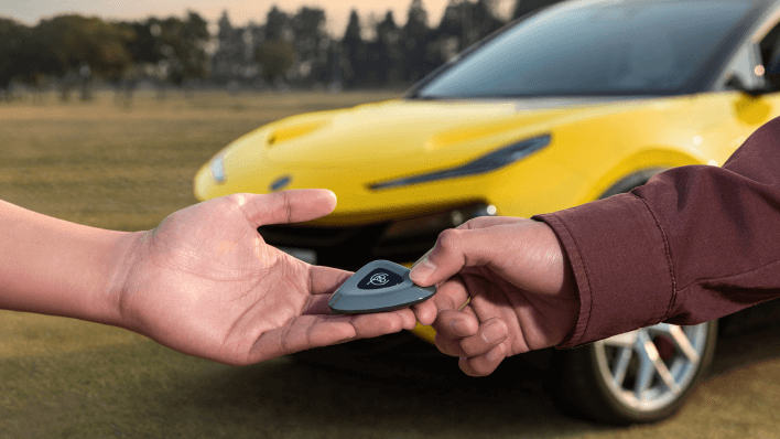 Vehicle key being handed to a customer
